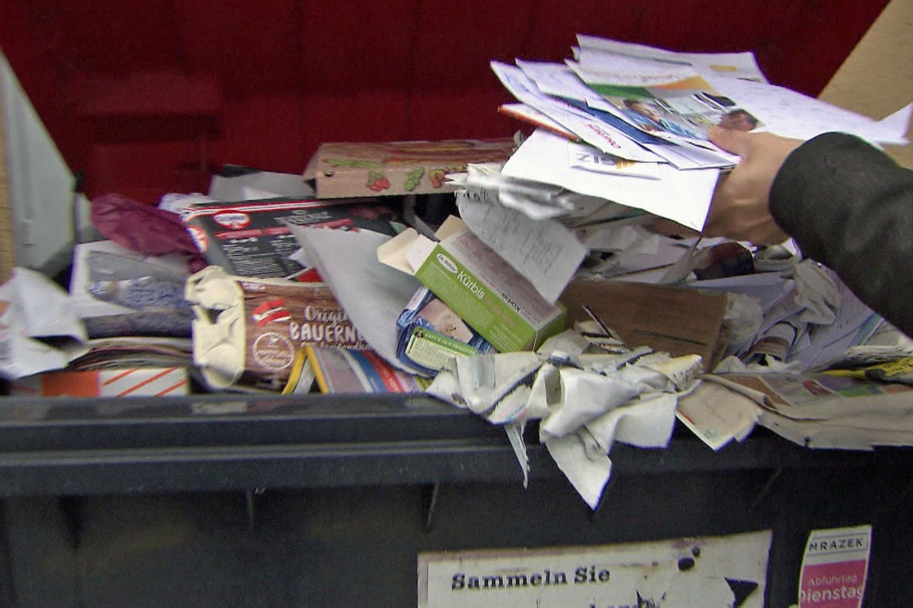 Waste paper is thrown into full waste paper containers